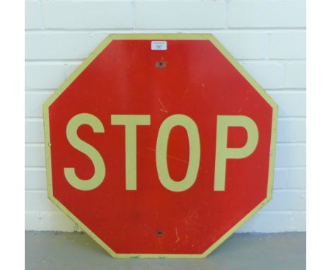 A vintage red and white enamel Stop sign of hexagonal shape, possibly American, 61 x 61cm 