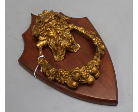 A 19th century Bacchus ormolu door knocker, on shield mount