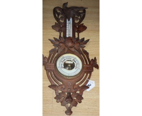 A Black Forest carved wall barometer, height 62cm