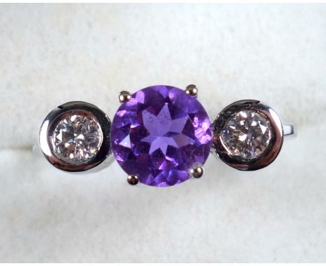 White metal ring set paste and 2 white stones, stamped "750", gross 5.7grs 
