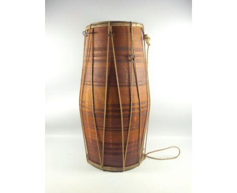 An African hide covered drum, 53cm, (split to one hide); African sandstone statue 32cm; two African carved busts of women, 27