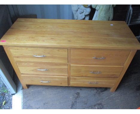 A contemporary light wood side cabinet having six drawers with metal bar handles 70cm h x 114cm w x 44cm 