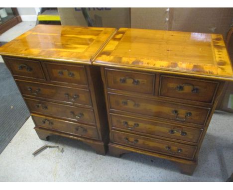 A pair of late 20th century yew five drawer bedside chests, on bracket feet, 82 h x 47cm w 