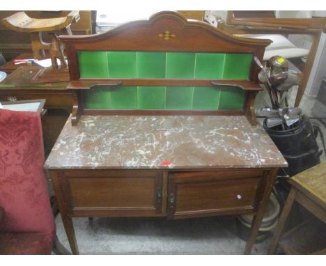 An Edwardian mahogany marble topped wash stand having a tile back and two cupboard doors below 135cm h x 107cm w 