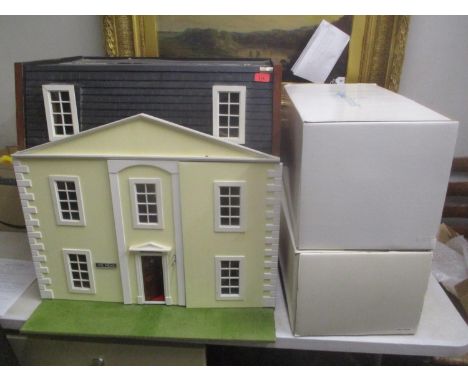 A large dolls house together with two boxed dolls entitled 'Sitting Pretty' and 'Baby's First Year' 