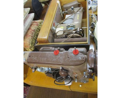 A 1950's Singer 201k sewing machine in brown, housed in a reptile style travelling case together with accessories and a vinta