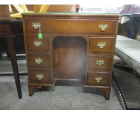 A reproduction mahogany inlaid kneehole desk with a door and seven drawers, on bracket feet, 76h x 76w x 47cm d 