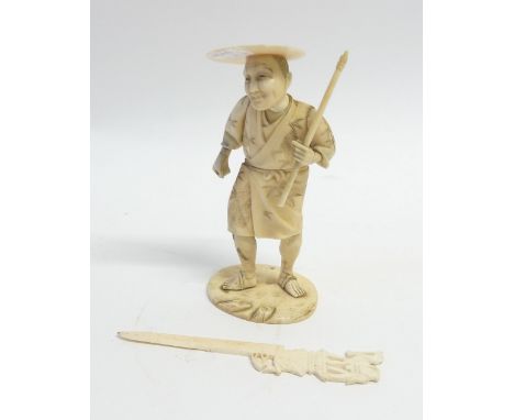 JAPANESE MEIJI PERIOD CARVED SECTIONARY IVORY OKIMONO, modelled as a man wearing floral robes and hat and holding a stick in 