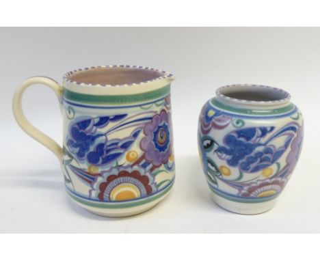 TWO MATCHING PIECES OF POOLE POTTERY, floral painted in colours beneath purple dashed rims, comprising TAPERING JUG with stra