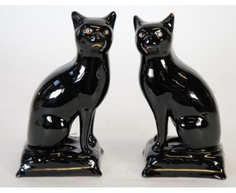 PAIR OF VICTORIAN BLACK GLAZED TERRACOTTA BODIED MODEL CATS,  with white enamel eyes and gilt, 7 1/4" (18.5cm)  high TOGETHER