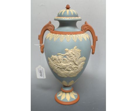 A Walker and Co light blue Jasperware two-handled pedestal ovoid vase and cover, applied in white with god in a chariot, the 