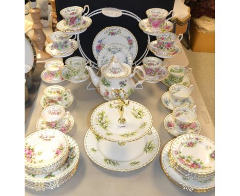 A Royal Albert Flowers of the month tea service for twelve, comprising two tier cake stand, teapot, side plates, dessert plat