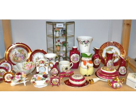A set of Franklin Porcelain Flowers of the Year in glazed miniature display cabinet; Limoges trinkets; a novelty miniature Fe
