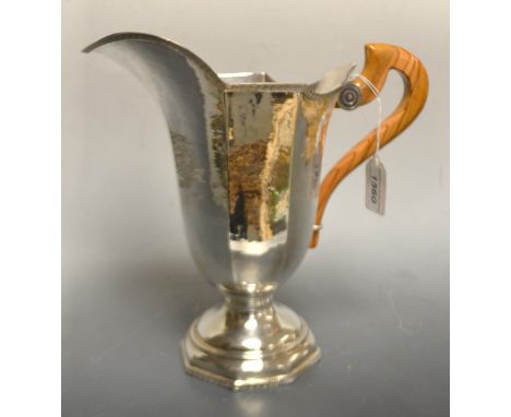 An Italian silver helmet shaped ewer, engine turned borders, planished overall, domed octagonal foot, wooden domed octagonal 