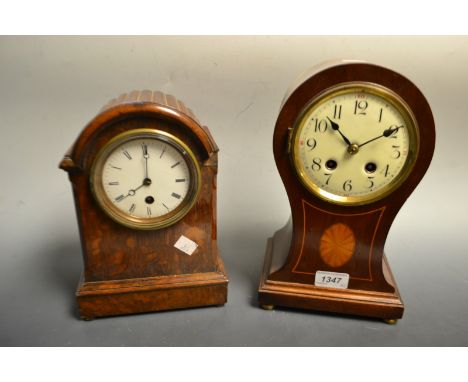 An Edwardian mahogany inlaid balloon shaped eight day mantel clock, Arabic numerals, four brass bun feet; an early 20th centu
