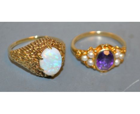 An opal dress ring, oval opal flashing red, purple, green and orange colour play, textured 9ct gold shank;  an Amethyst and s