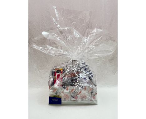 Blooms the Chemist hamper containing perfume, male and female toiletry bags, chocolates, hand cream and mug. 