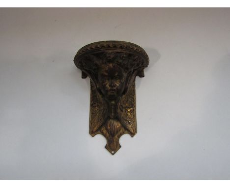 A gilt worn metal wall bracket, cherub form, 14cm tall