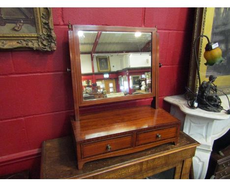 Circa 1850 a crossbanded chequer strung inlaid toilet mirror the tilting mirror over two base drawers on bracket feet, 63cm x