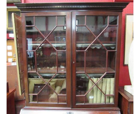 A George III style mahogany and burr walnut bookcase bureau, two astragal glazed doors over a fitted interior and four long d