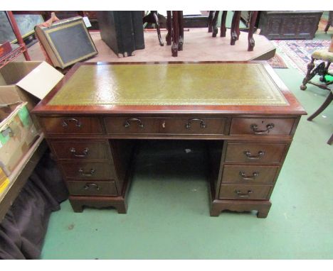 A Georgian style mahogany twin pedestal desk, the tooled leather green inset writing surface over eight drawers on bracket fe