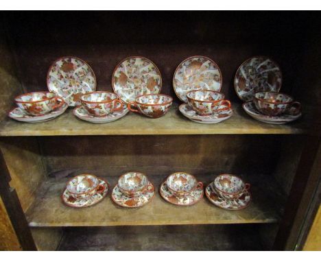 A quantity of Chinese tea cups and saucers with floral decoration and butterflies, nine cups and twelve saucers (21) 