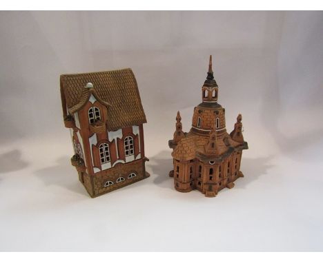 Four terracotta candle/tea light holders in the form of cottages   