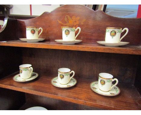 A set of six Royal Doulton small coffee cups and saucers, decorated with fruit and gilt edged