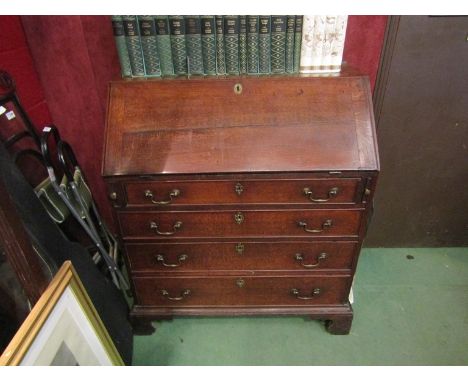 A Georgian oak bureau with fitted interior, four graduating long drawers with swan neck handles on bracket feet, 105cm high x
