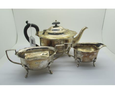 A Hallmarked Silver Three Piece Tea Set, M&amp;J, Birmingham 1931, each of plain oval form with wavy edge, on pad feet (total