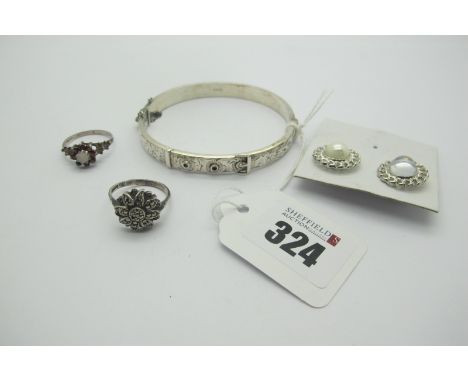 A Hallmarked Silver Hinged Bangle, of belt buckle design to the front, together with a marcasite set flowerhead cluster ring,