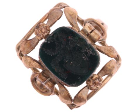 A 9ct gold bloodstone armorial seal ring, intaglio carved with tree in shield surmounted by knight and wings, setting height 