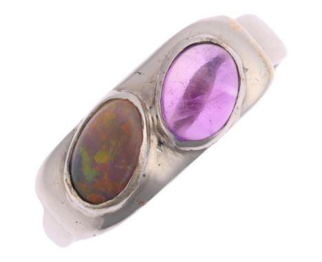 A 9ct white gold black opal and amethyst dress ring, maker CPM, Birmingham 2004, rub-over set with oval cabochon gemstones, s