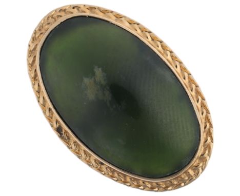 An 18ct gold jadeite jade panel ring, set with oval cabochon jade, setting height 25.2mm, size P, 5.7g Condition Report:No da