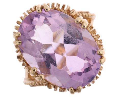 A 1970s 9ct gold amethyst dress ring, maker SJ, London 1971, claw set with oval mixed-cut amethyst and textured shoulders, se