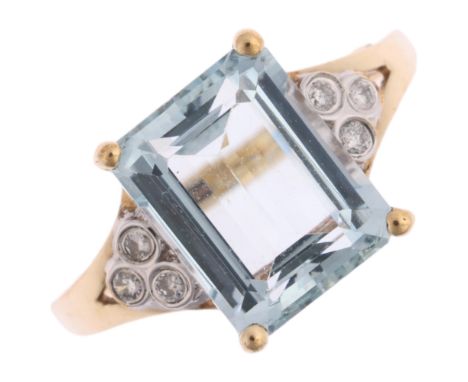 A 9ct gold aquamarine and diamond dress ring, claw set with 3ct rectangular step-cut aquamarine, flanked by trio of modern ro