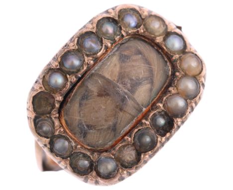 A Georgian hairwork split pearl mourning ring, circa 1820, the central woven hairwork panel beneath convex glass surrounded b