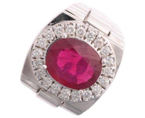 A large 14ct white gold ruby and diamond cluster signet ring, maker JI, centrally claw set with 7ct oval mixed-cut ruby surro