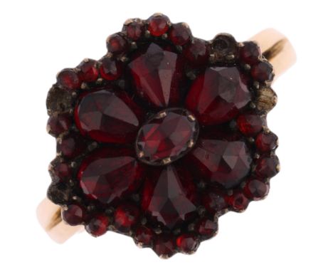 An Antique Bohemian garnet flowerhead cluster ring, on later 9ct gold shank, setting height 13.8mm, size M, 3.5g Condition Re