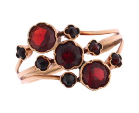 A French 9ct gold garnet flowerhead dress ring, setting height 13.6mm, size N, 1.9g Condition Report:No damage or repair, all