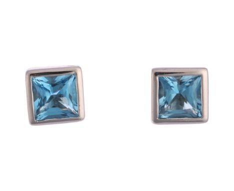 A pair of blue topaz earrings, rub-over set with Princess-cut topaz, stud fittings, apparently unmarked, 6.5mm, 3.7g Conditio