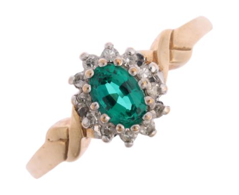 A 9ct gold emerald and diamond flowerhead cluster ring, maker CG, claw set with oval mixed-cut emerald and single-cut diamond
