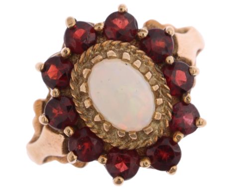 A 9ct gold opal and garnet flowerhead cluster ring, maker G&TJ, London 1975, set with oval cabochon opal and round-cut garnet