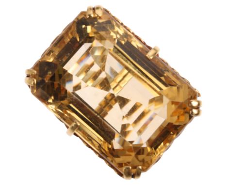 A large 1970s single stone citrine dress ring, claw set with rectangular step-cut citrine, apparently unmarked, 26.5mm, size 