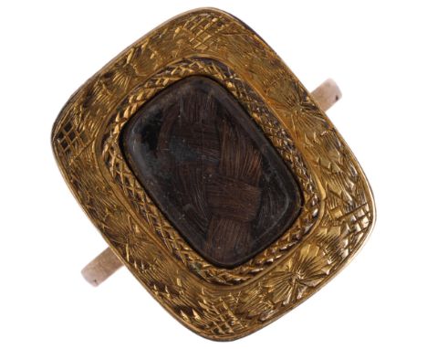A Georgian hairwork mourning ring, circa 1820, the central woven hair panel beneath bevelled-edge glass within engraved surro