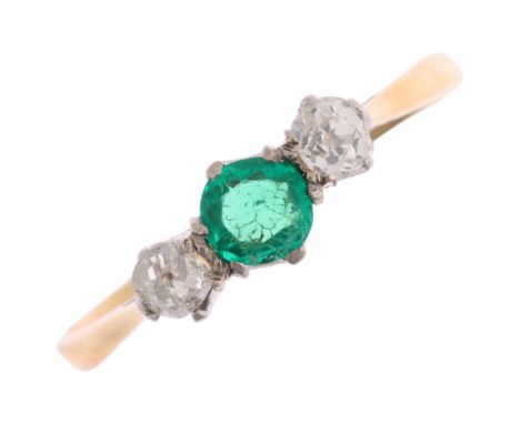 An Art Deco 18ct gold three stone emerald and diamond ring, platinum-topped set with round-cut emerald and old-cut diamonds, 