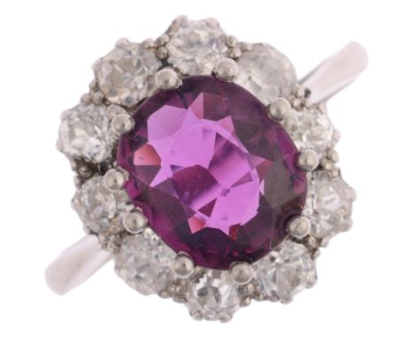 A platinum synthetic ruby and diamond flowerhead cluster ring, claw set with oval mixed-cut synthetic ruby surrounded by old 
