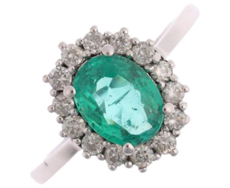 An emerald and diamond oval cluster ring, claw set with oval mixed-cut emerald and modern round brilliant-cut diamonds, total