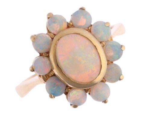 A 14ct gold opal flowerhead cluster ring, set with oval and round cabochon opals, setting height 15.6mm, size L, 5g Condition