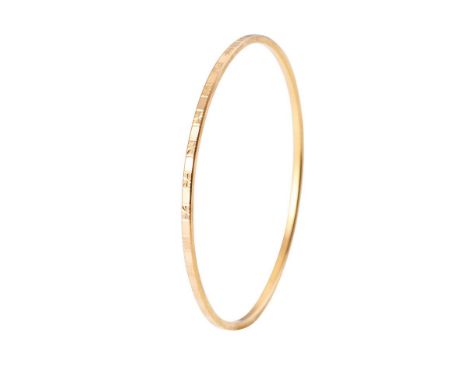 Yellow metal (tests as 18ct or better) circular bangle with engraved decoration, 62mm diameter, 11.0 grams.  